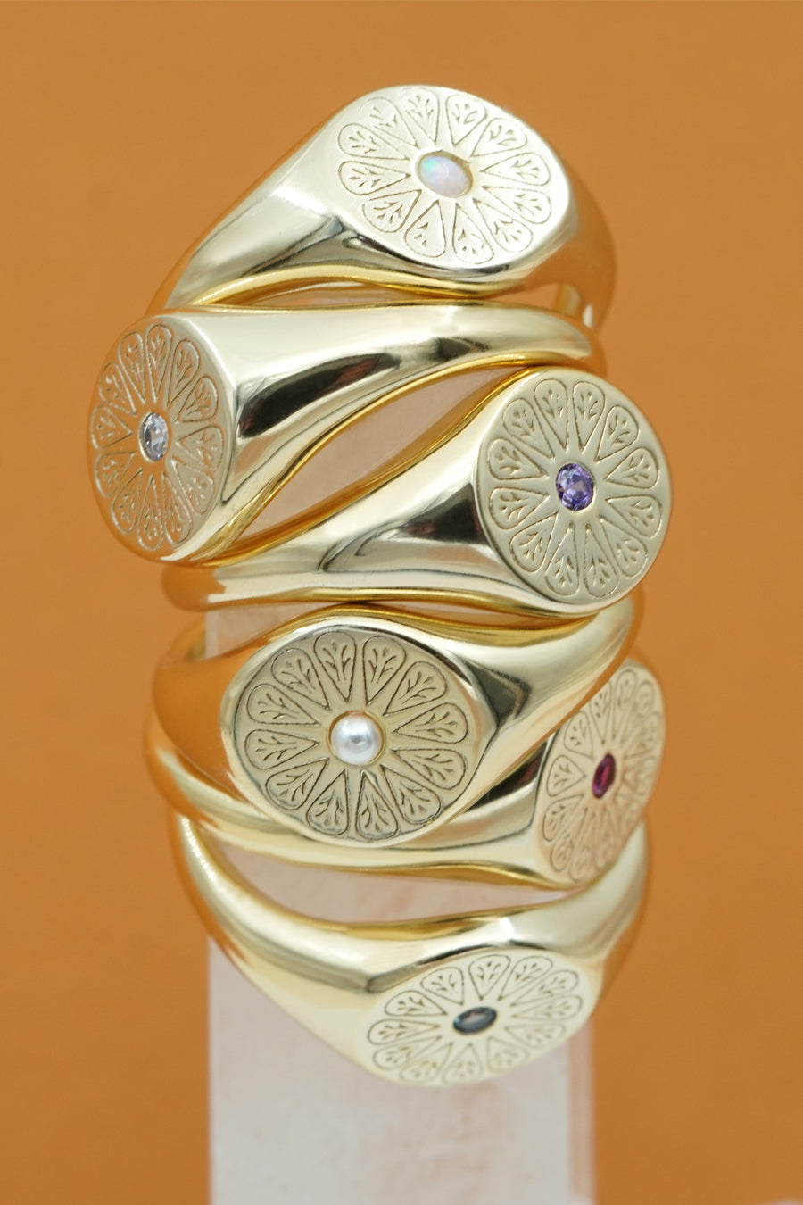 Gold July Ruby Birthstone Rings stacked with other rings