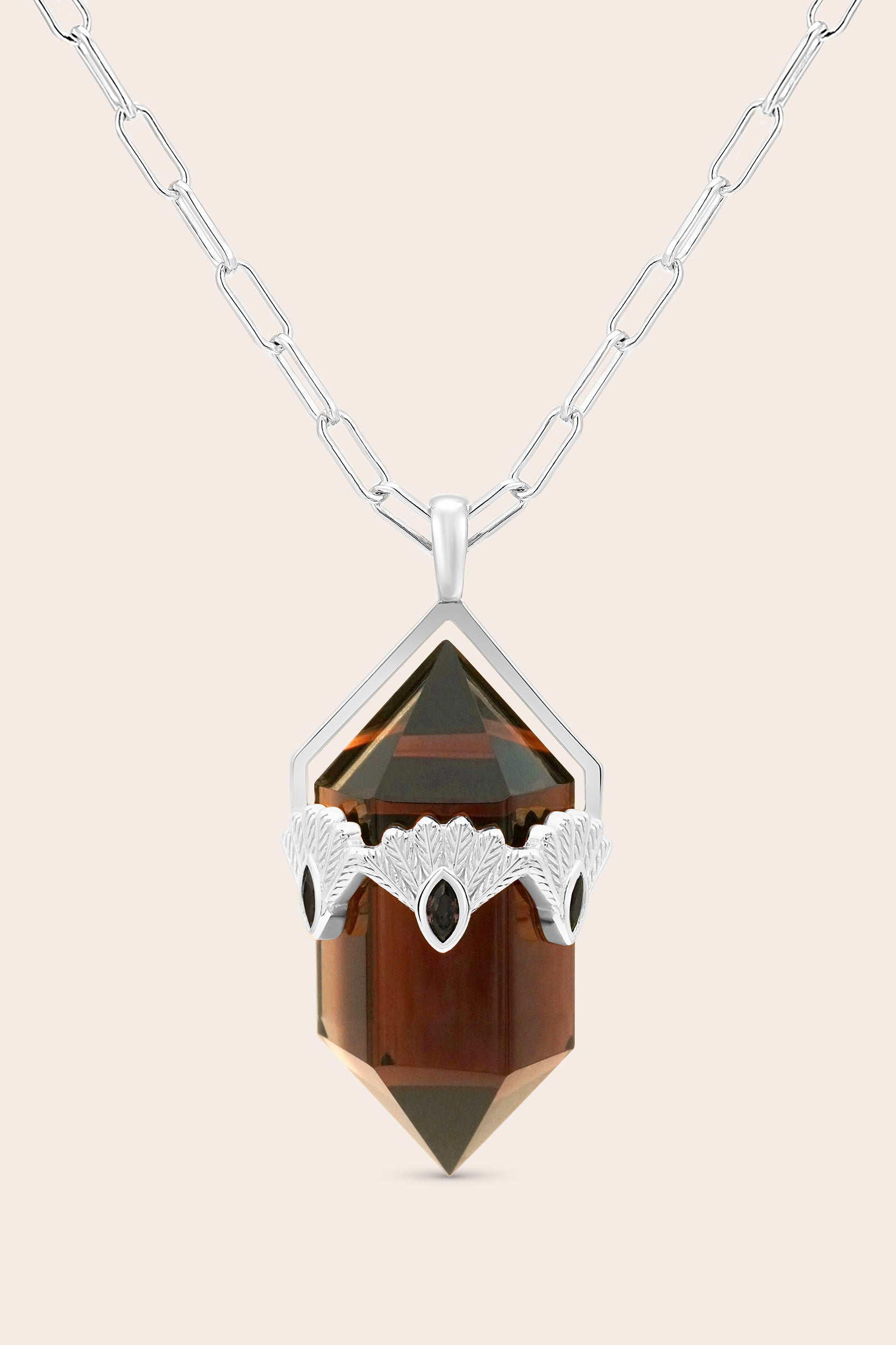 Silver Fantail bid Necklace with a brown pendant on a beige background