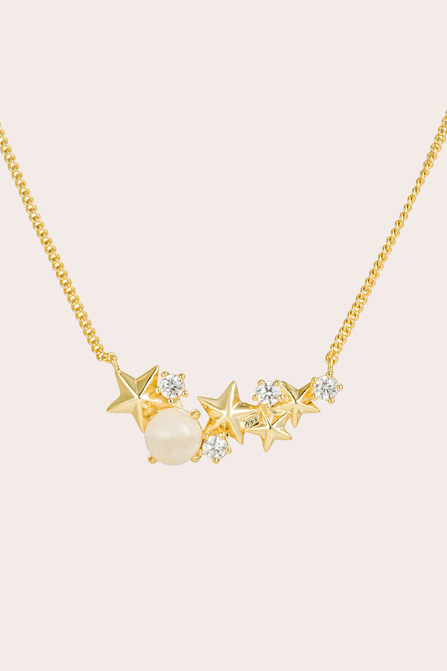 Gold Matariki Necklace on cream background