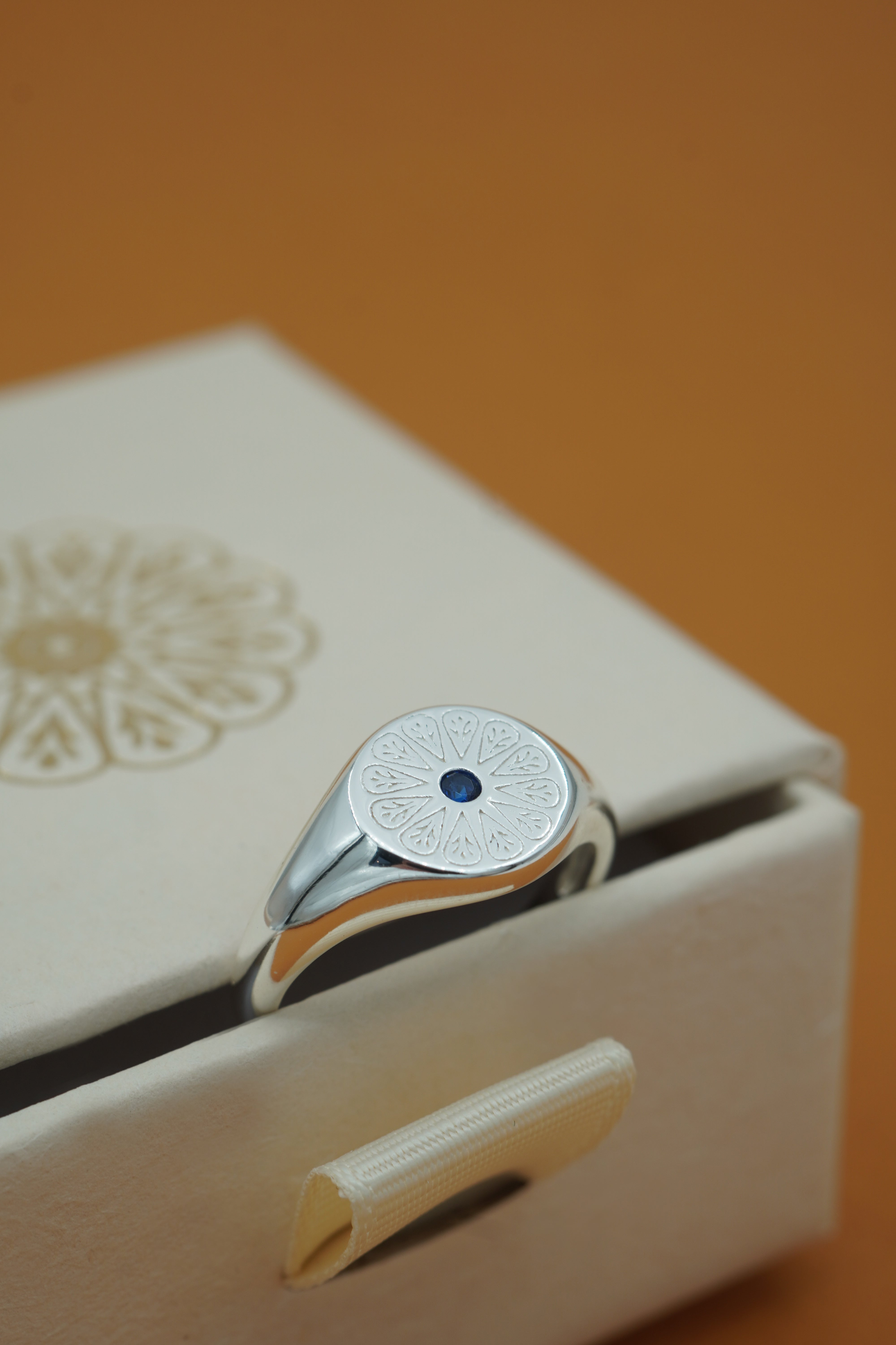 Silver Sapphire Birthstone Signet Birthstone Ring on cream box