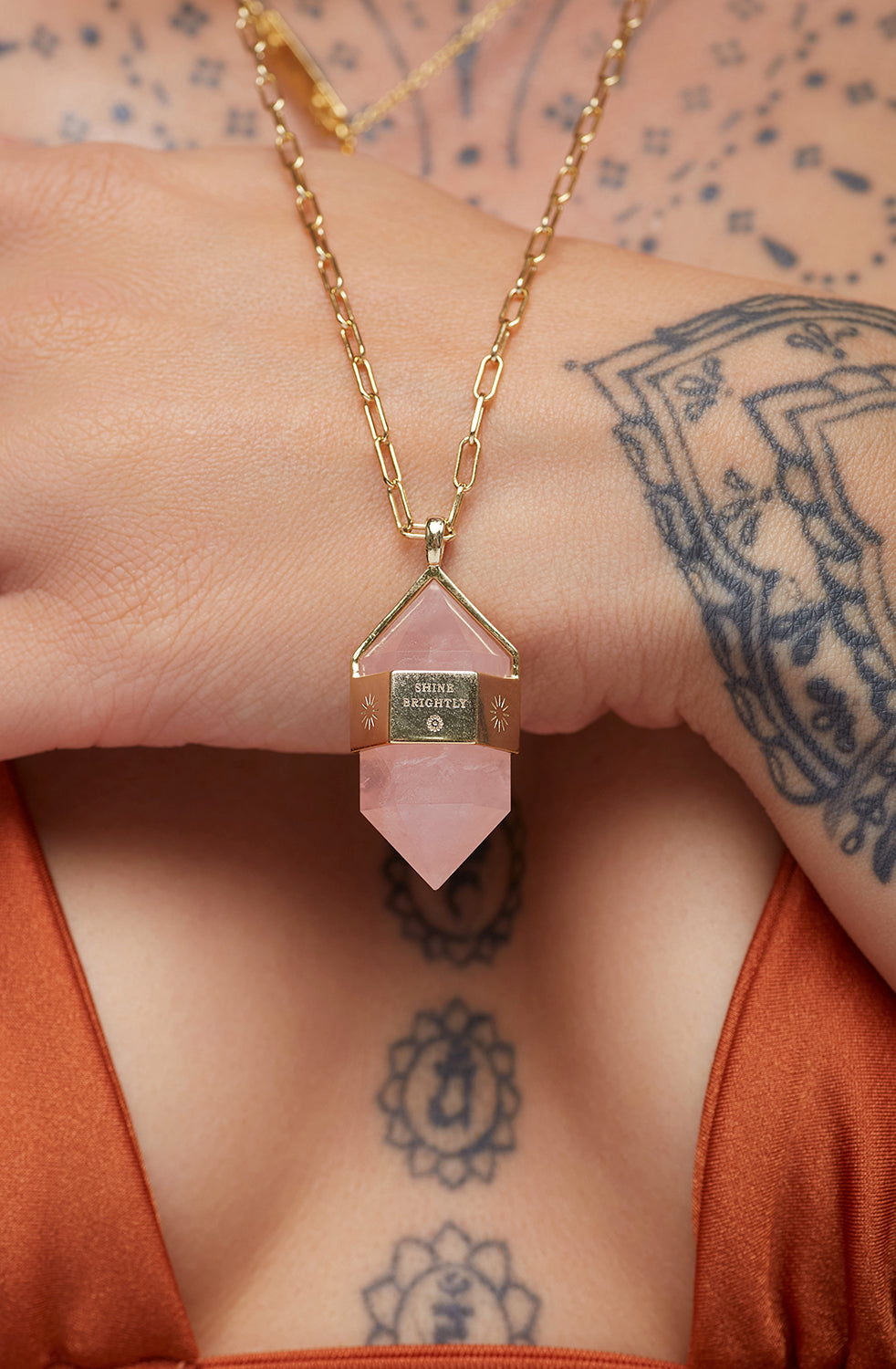 Rose Quartz Pendant Necklace on top of hand