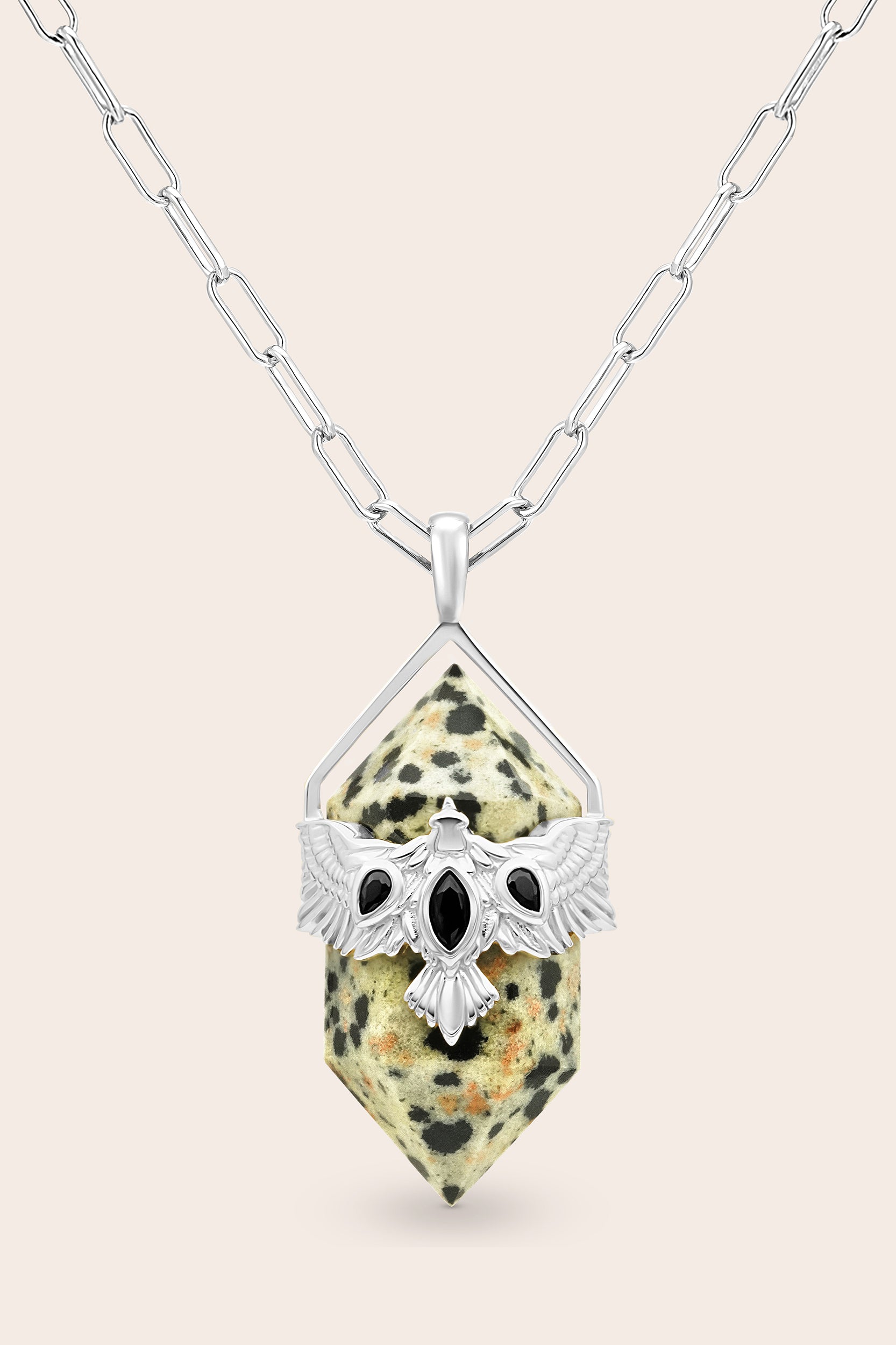 Necklace with a pendant featuring a natural stone and silver hawk bird design on a beige background