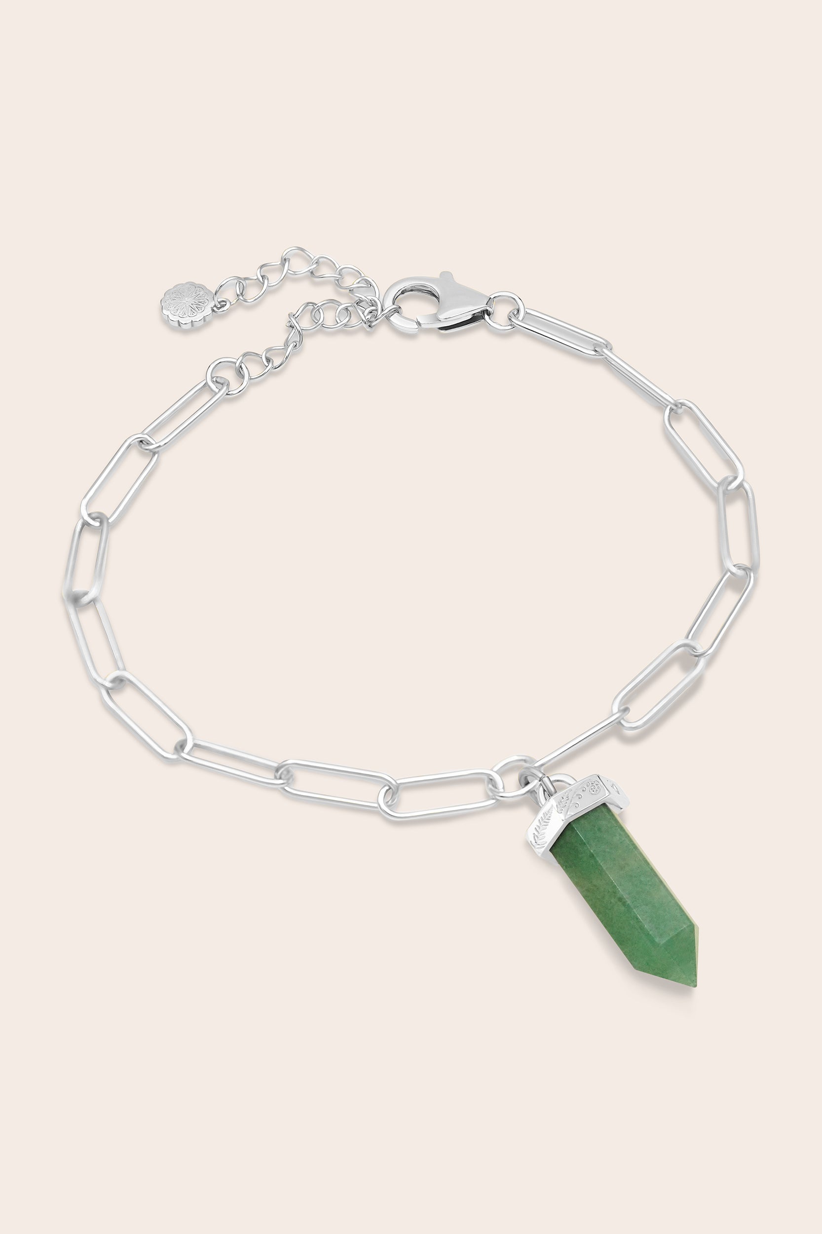Silver paperclip chain bracelet with a green aventurine crystal pendant on a beige background