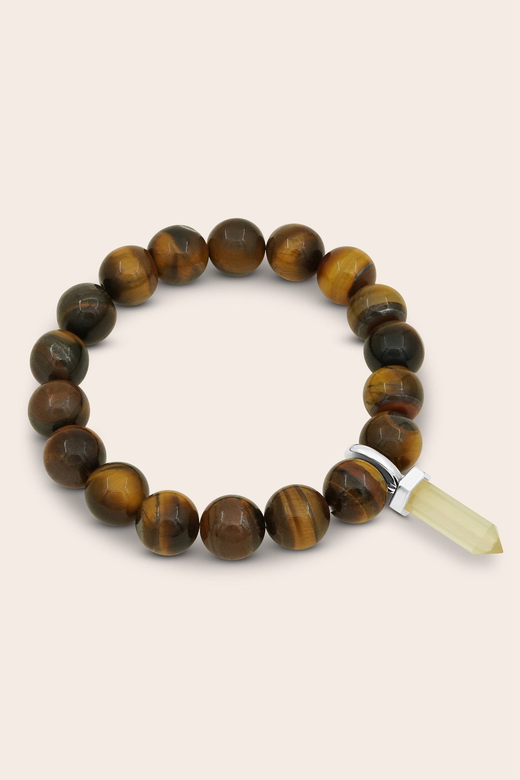 Tigers Eye beaded bracelet with tiger eye stones and a clear crystal on a beige background