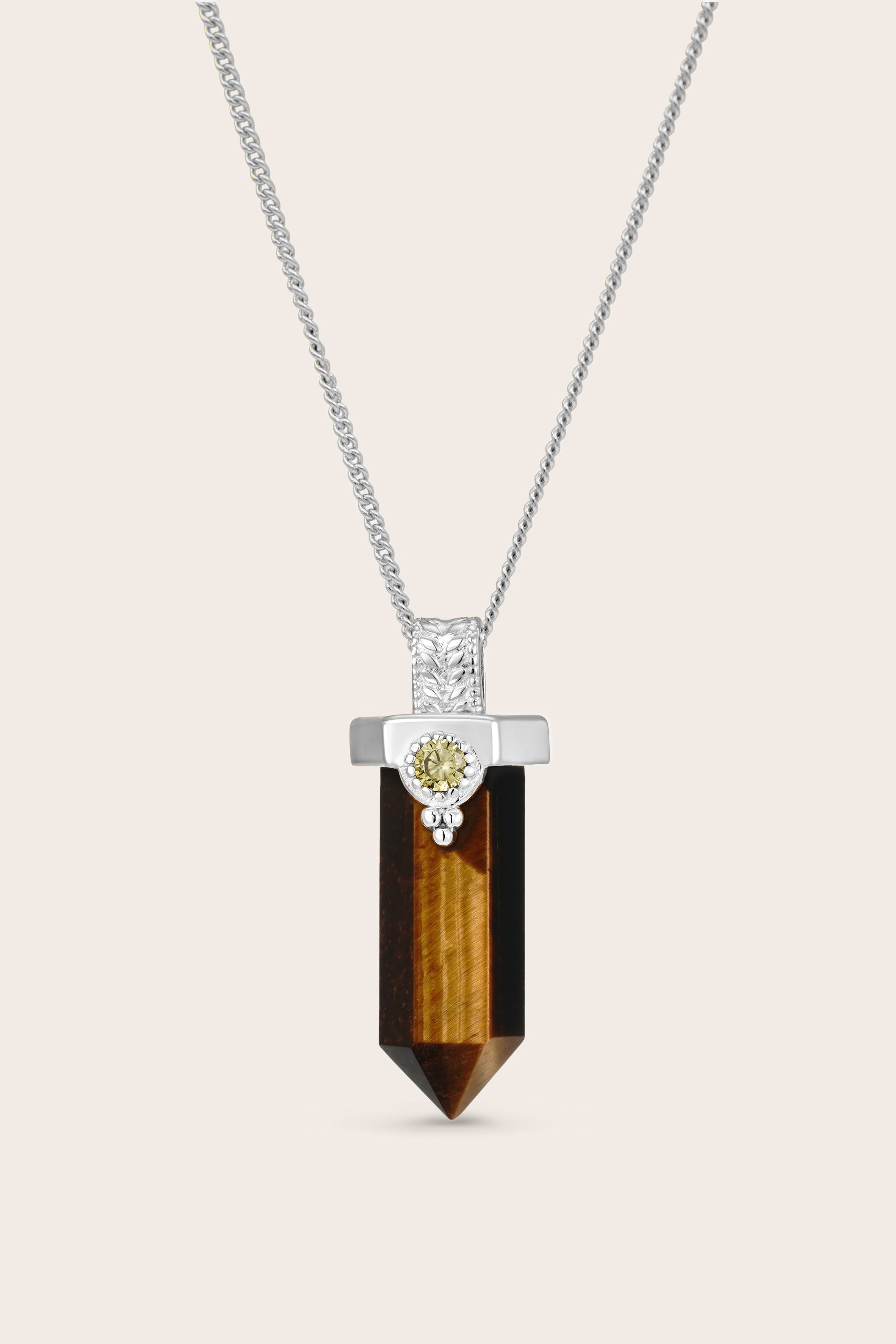 Necklace with a tiger's eye pendant on a light beige background