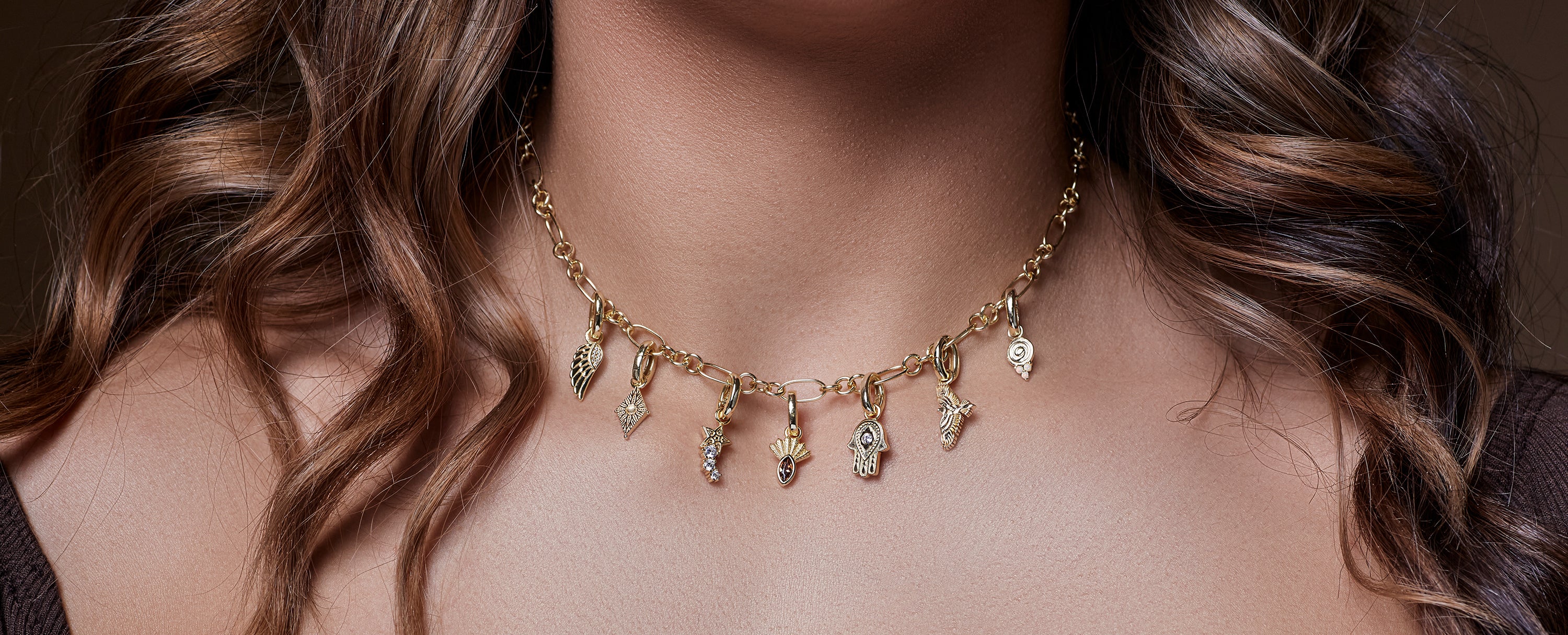 charm necklace in gold on neck