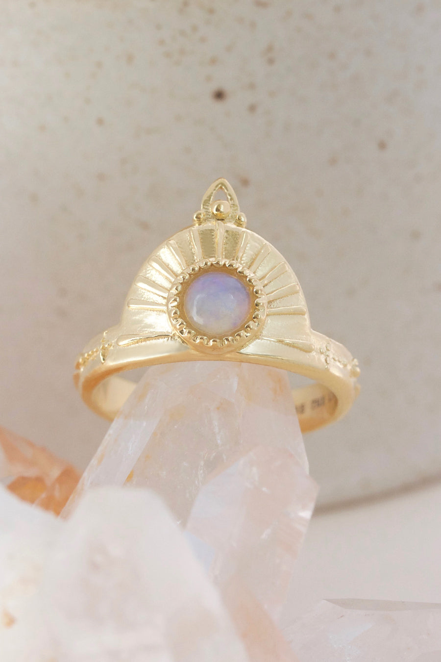 opal ring in gold on crystal background