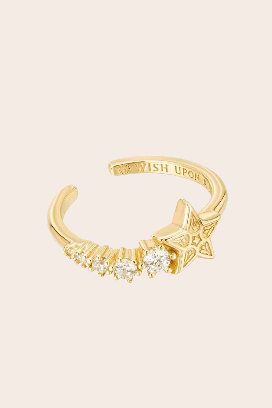 Gold shooting star ring on cream background