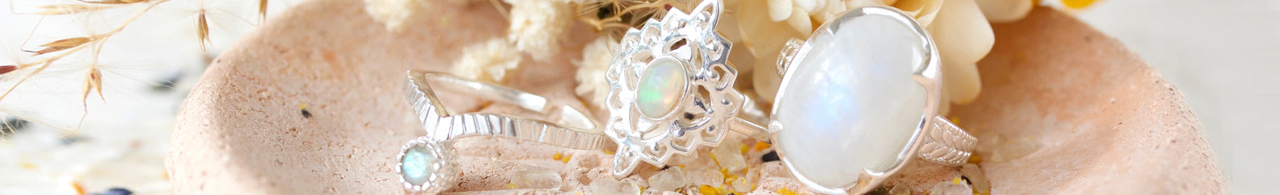 moonstone jewellery silver rings on pink ceramic plate