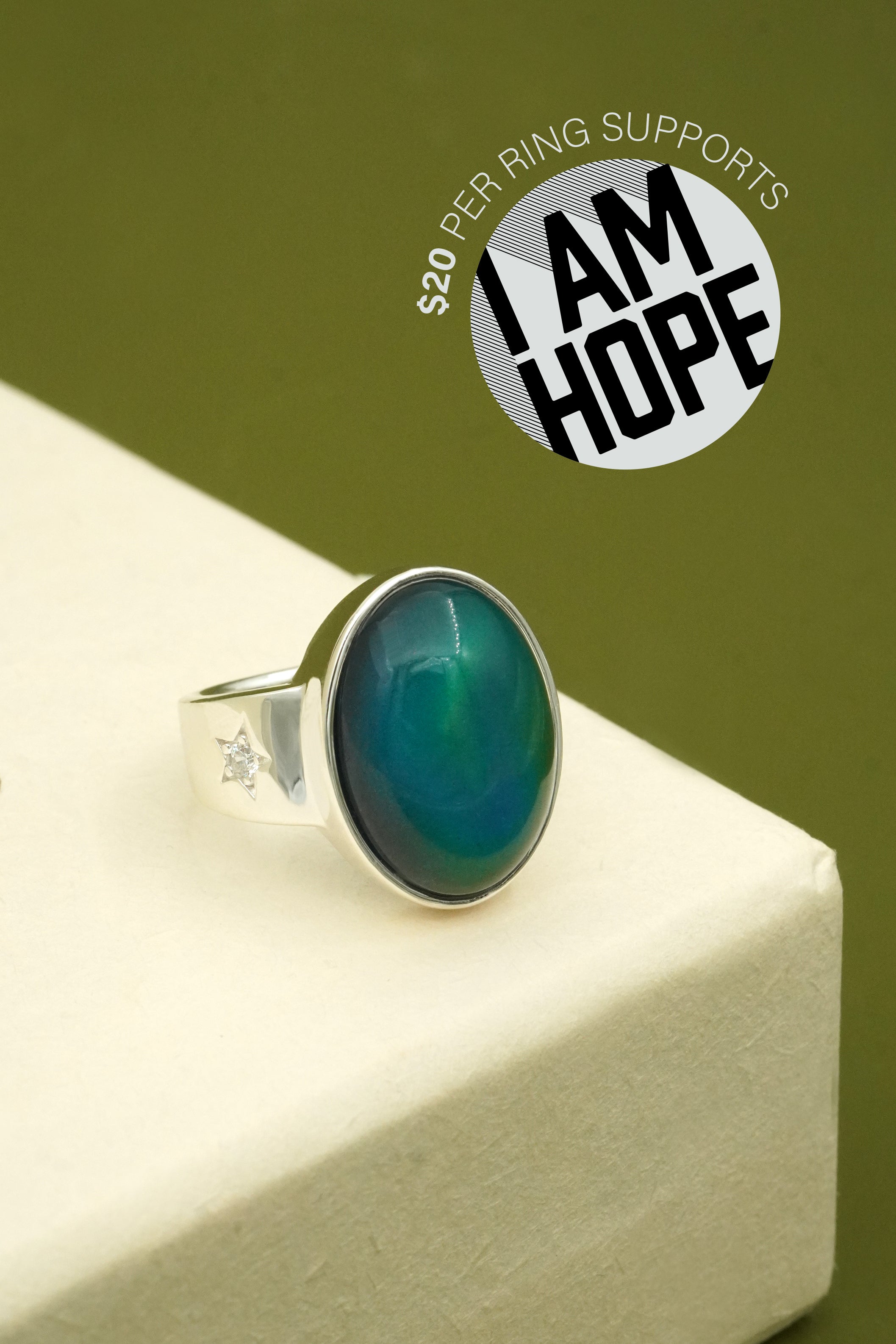 Mood Ring on a white surface with a green background, featuring 'I AM HOPE' logo.