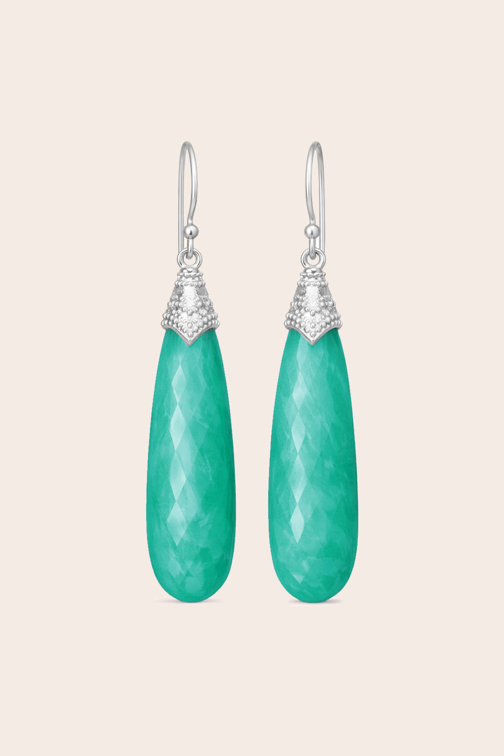 Pair of green amazonite teardrop earrings with silver accents on a light beige background