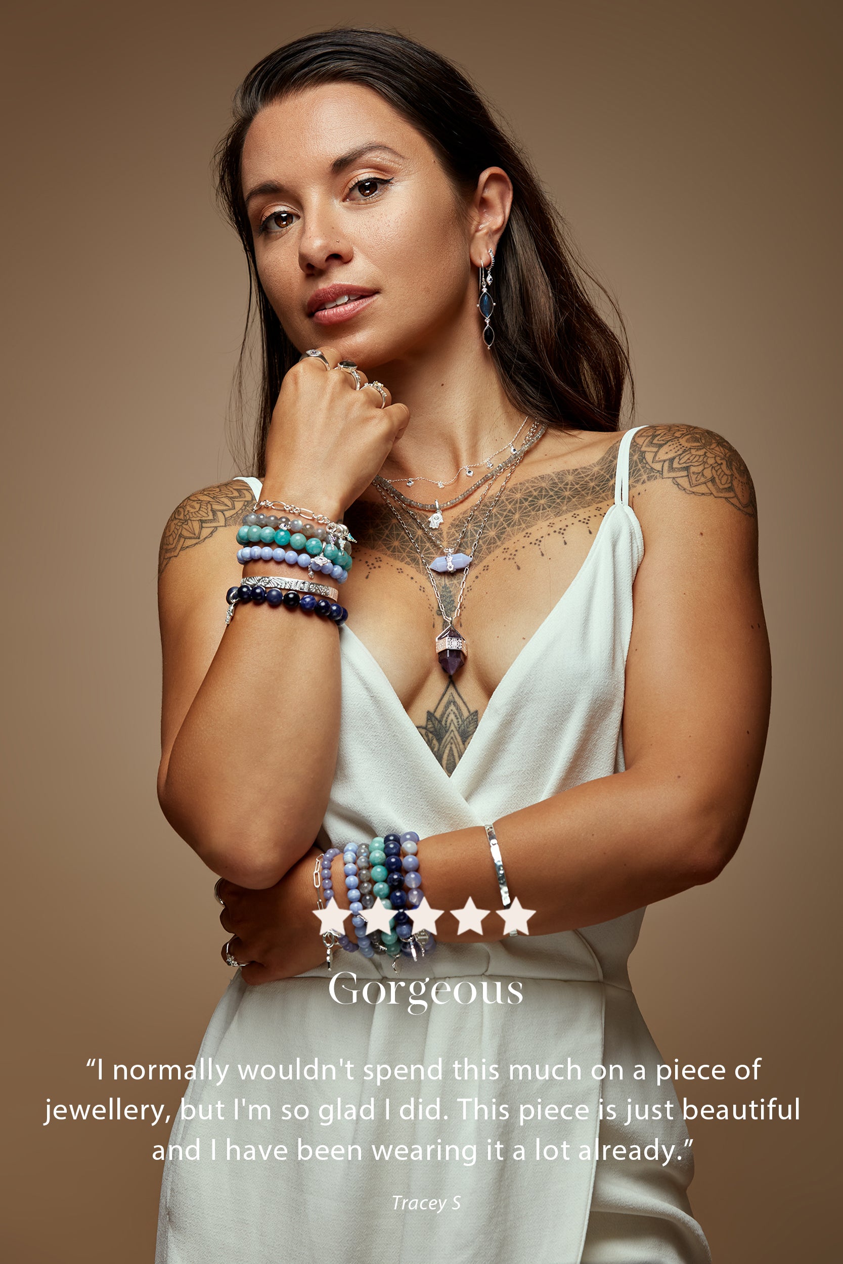 Woman wearing colorful bracelets and a necklace on a brown background