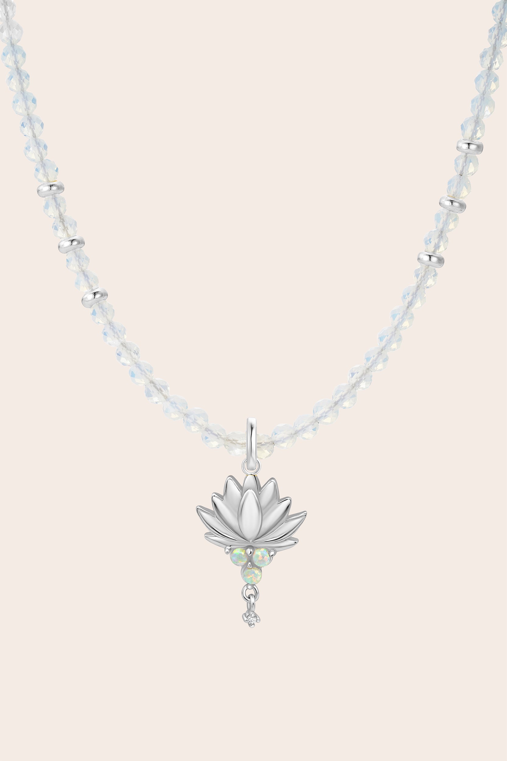 Lotus Opal Necklace with a silver lotus flower pendant on a light background