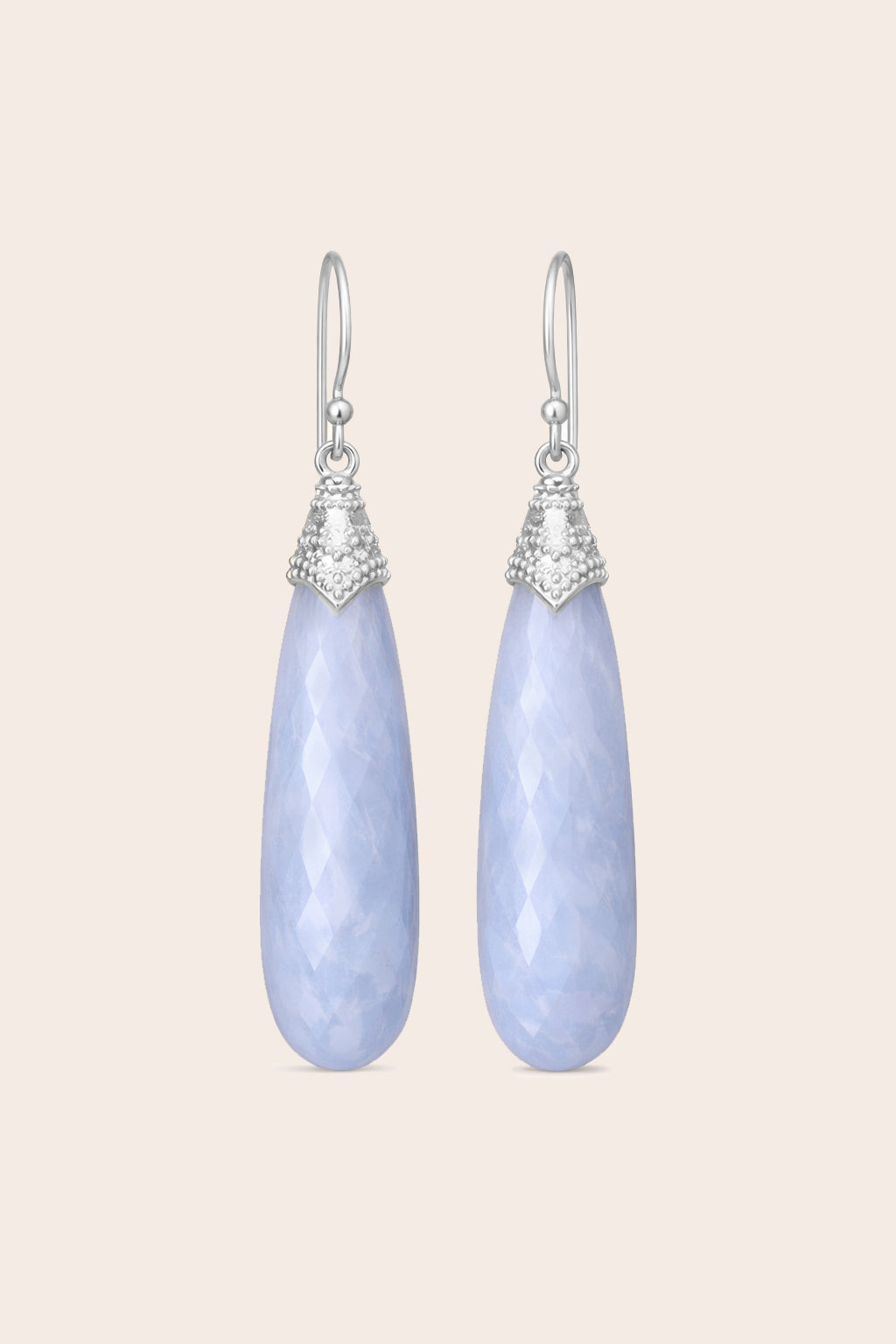 Pair of blue lace agate light blue teardrop earrings with silver accents on a light pink background