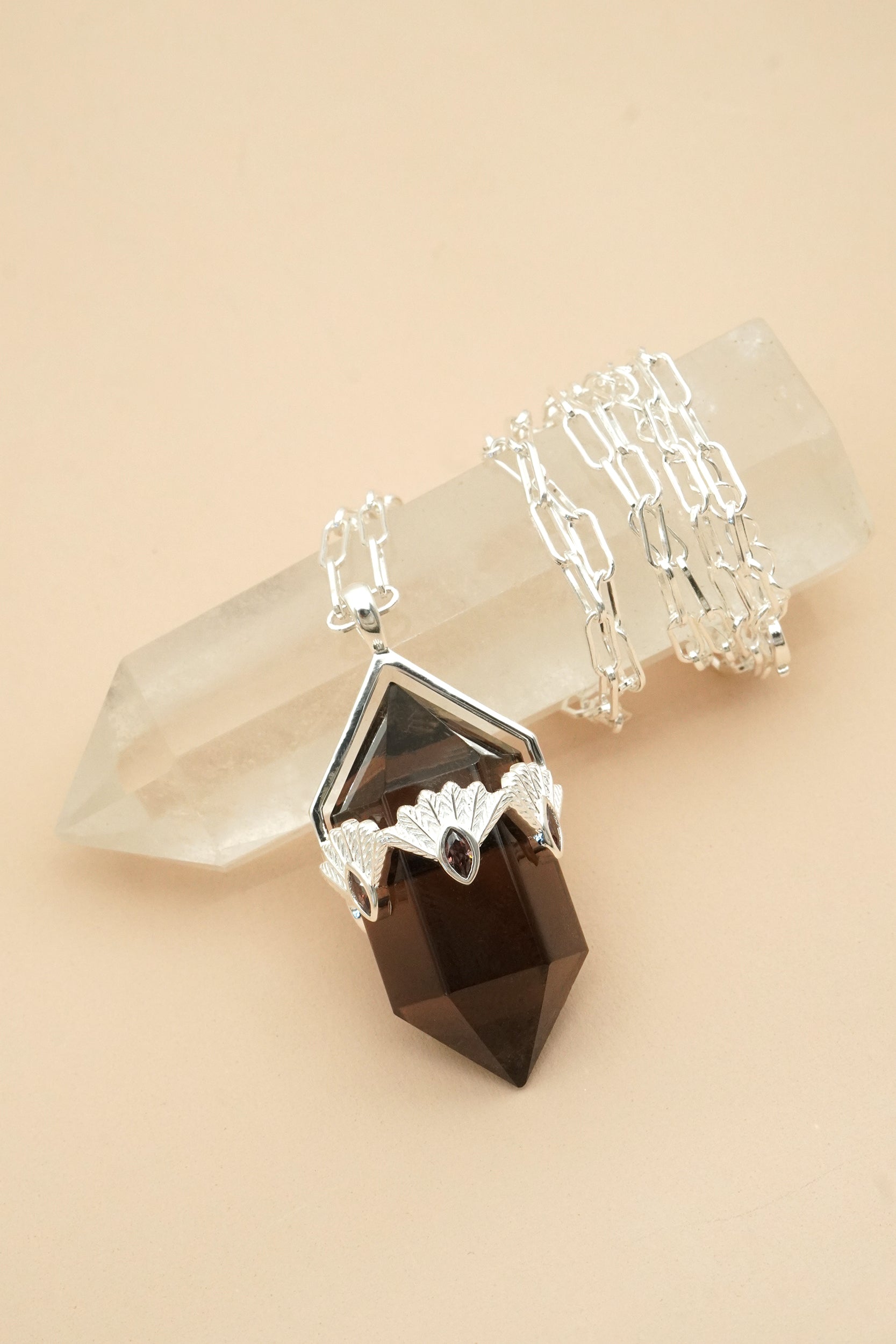 Brown Crystal necklace with smoky and clear stones on a beige background