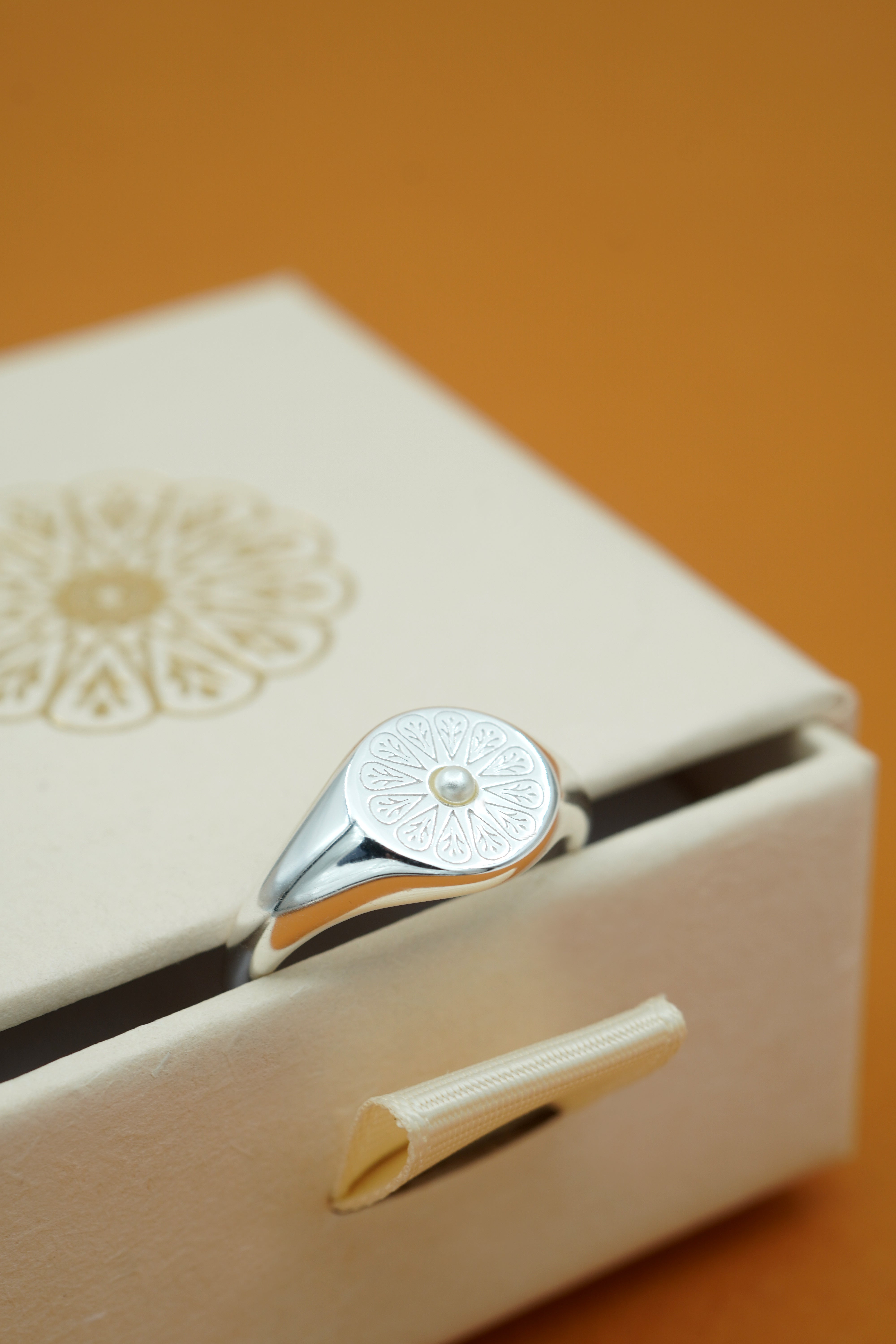 Silver June Signet Birthstone Ring on cream box