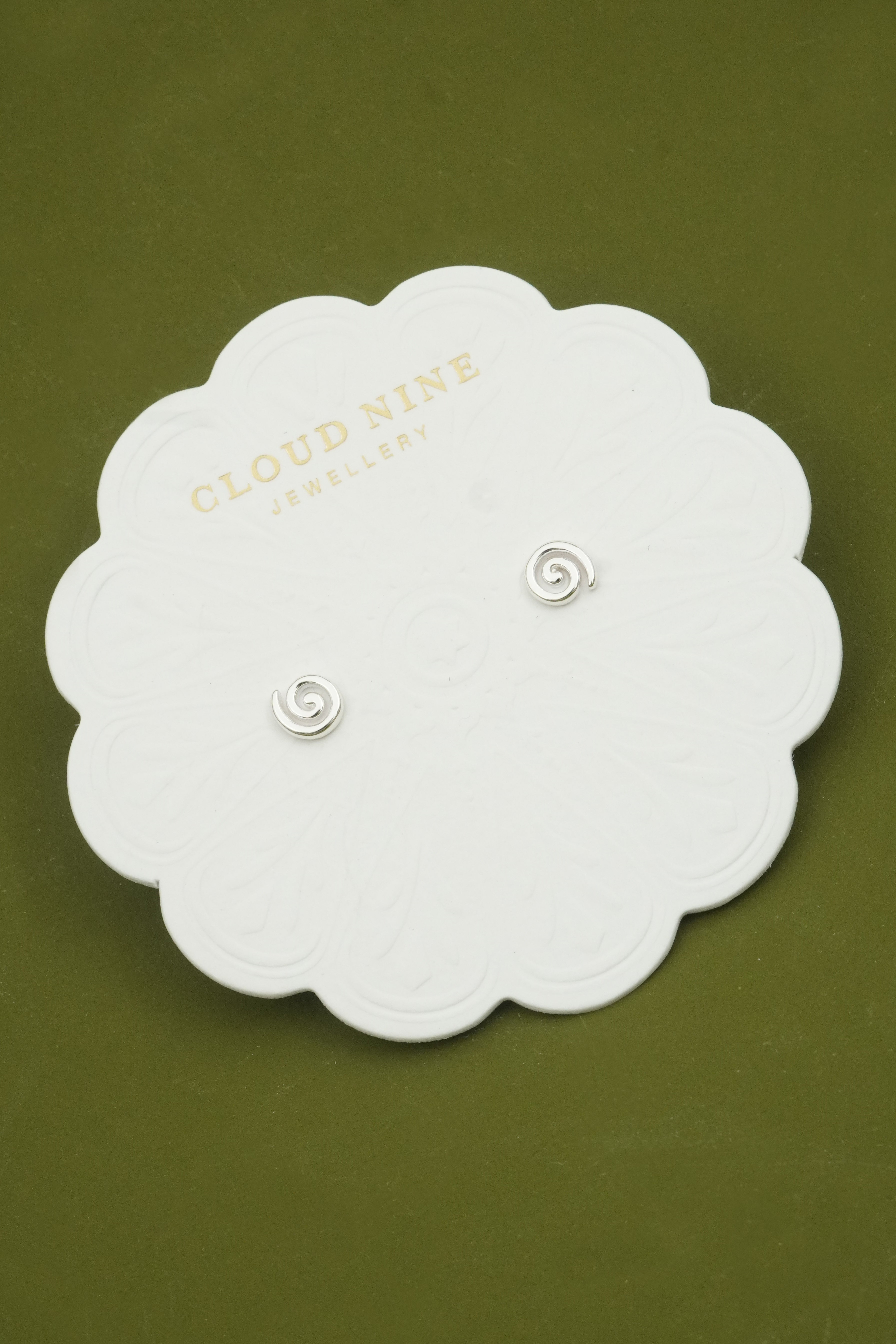 Silver earrings on a white card with 'Cloud Nine Jewellery' branding on a green background
