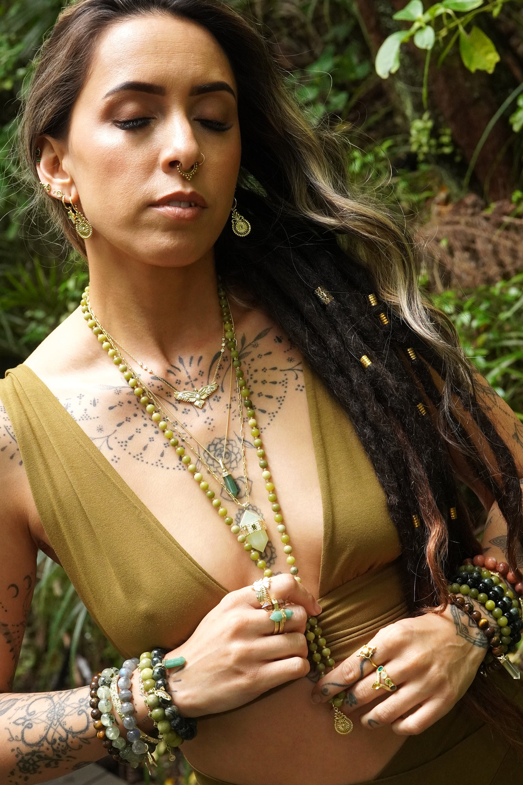 Girl wearing gold layered jewellery in NZ nature background