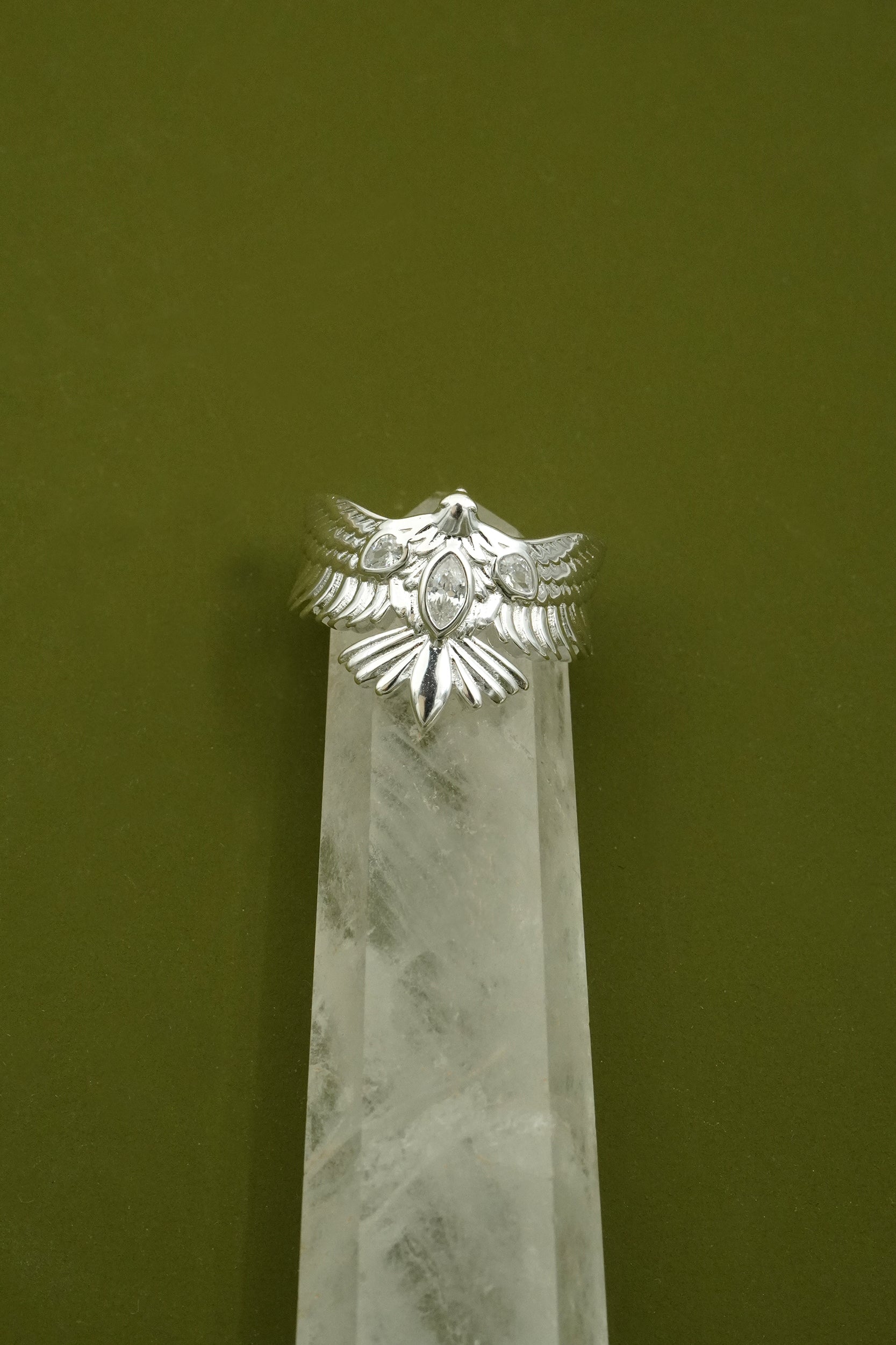 Sterling silver Haw with wings out ring on a green background