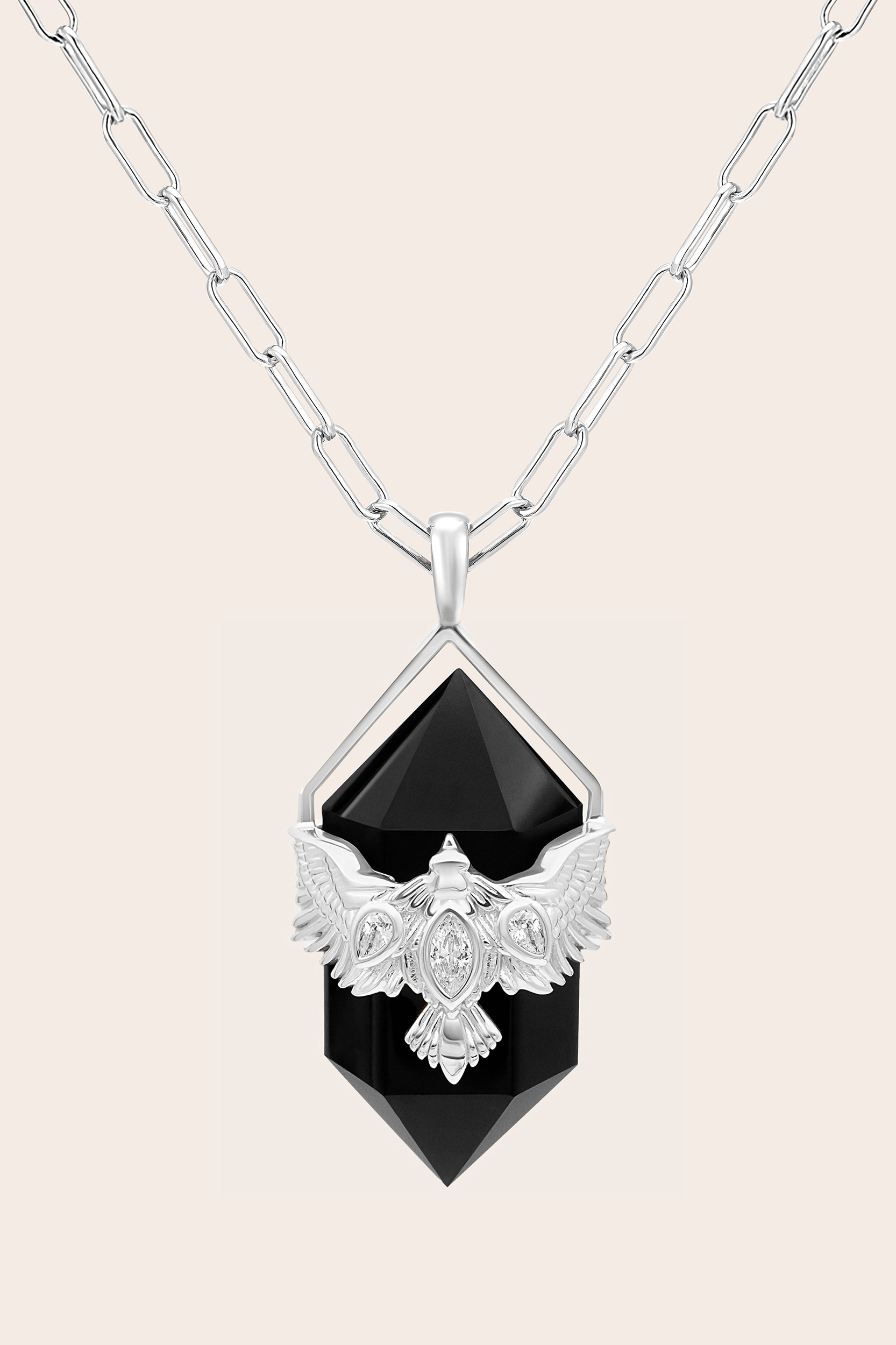 Silver Necklace with a black agate gemstone pendant and silver chain on a cream background