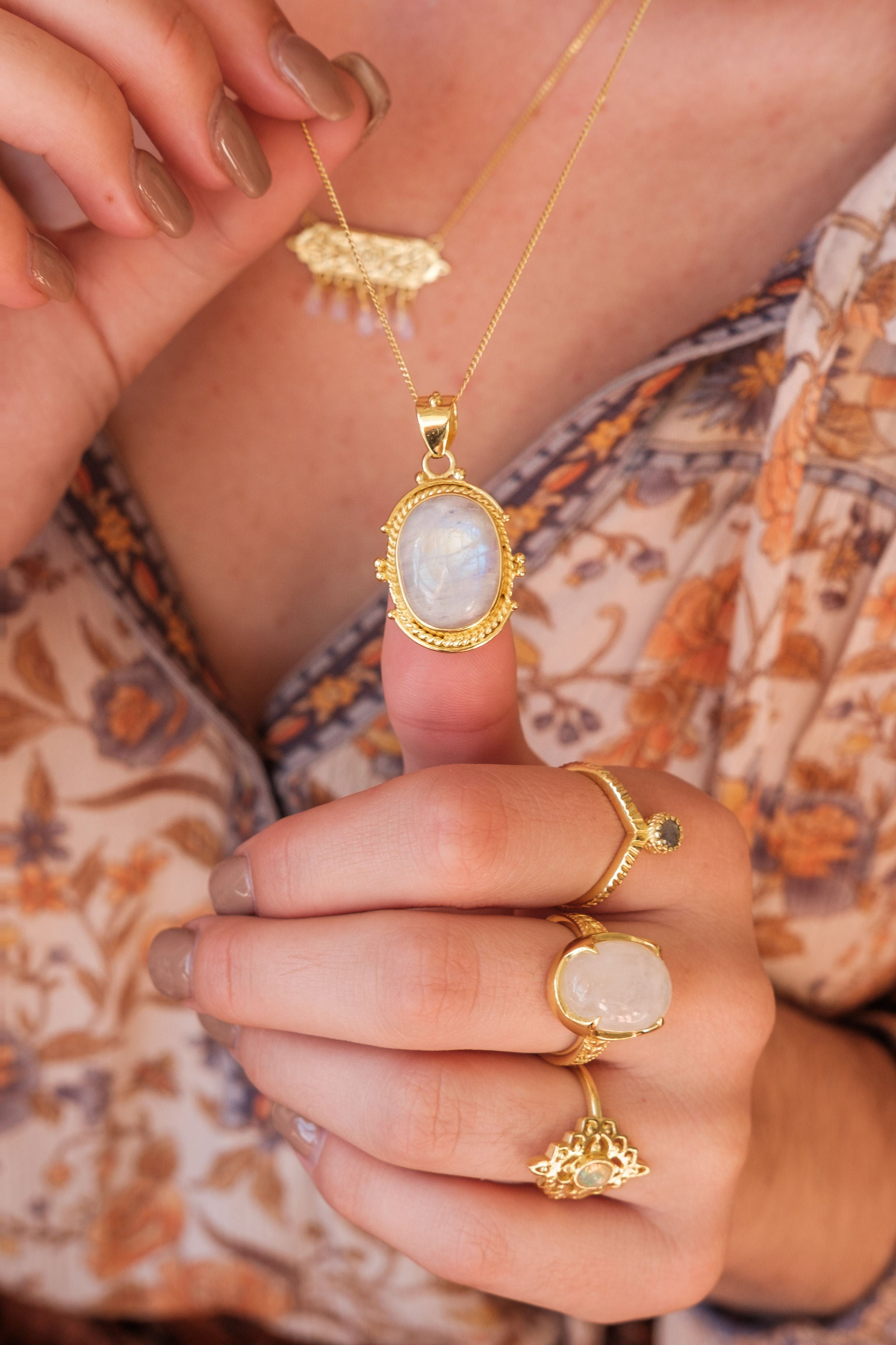 moonstone moon ring and matching necklace on model showing  hands