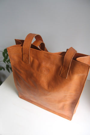 Tan Leather Tote Bag on cream background